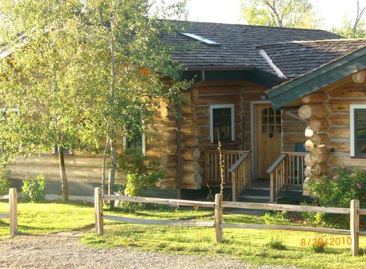 Exterior of Bozeman log cabin in summer
